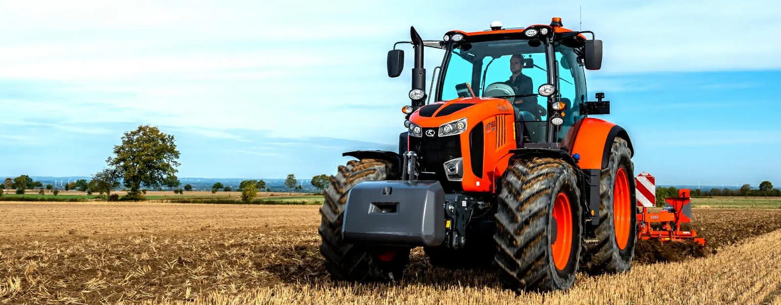 Tractor preparing a farm field for planting