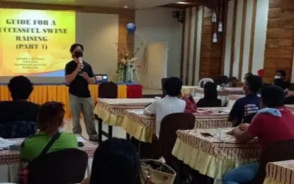 Livestock raisers attending a successful swine raising seminar